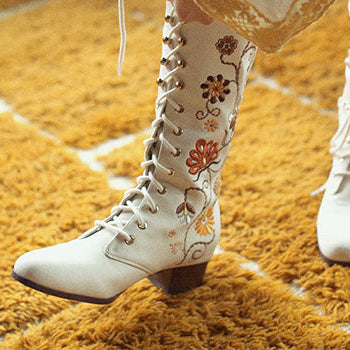 Hero banner for women's boho and 70s inspired boots and shoes from The Hippie Shake - Close up of cream embroidered Penny Lane boots.