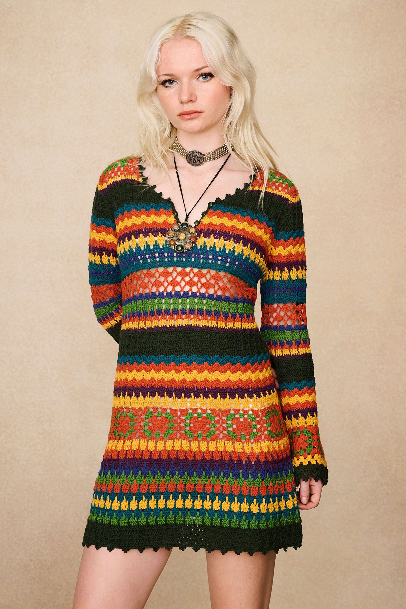 Model wearing The Hippie Shake's 70s inspired multicolour striped crochet mini dress.
