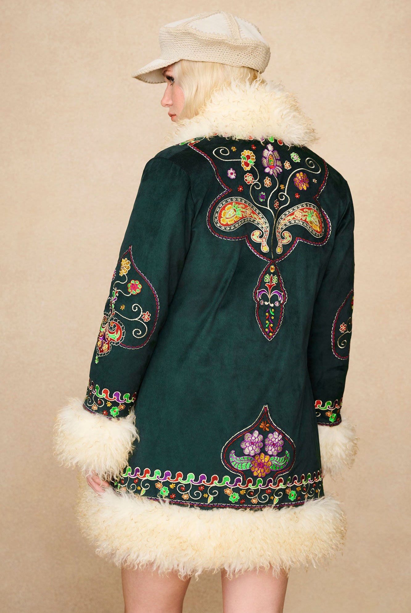 Back view of The Hippie Shake's green afghan coat highlighting symmetrical floral embroidery and faux shearling collar.
