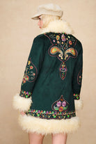 Back view of The Hippie Shake's green afghan coat highlighting symmetrical floral embroidery and faux shearling collar.