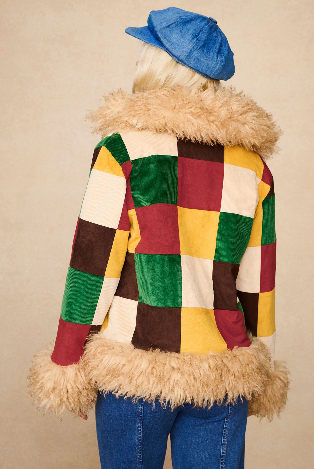 Back view of The Hippie Shake's patchwork Penny Lane coat with vibrant cord squares and faux fur trim.