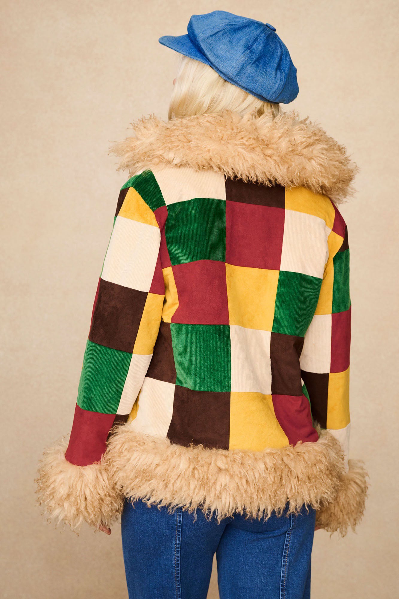 Back view of The Hippie Shake's patchwork Penny Lane coat with vibrant cord squares and faux fur trim.