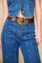 Detailed front view of The Hippie Shake's chevron flared jeans featuring exposed zip and chevron stitch pockets.
