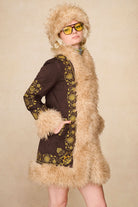 Model wearing The Hippie Shake's brown embroidered Penny Lane coat with our 70s style faux fur trim hat and yellow sunglasses.