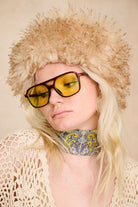 Model wearing The Hippie Shake's 70s inspired faux fur hat with yellow sunglasses, floral scarf and our cream crochet top.
