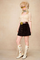 Model styling The Hippie Shake's 70s style Penny Lane boots with a crochet top and mini skirt.