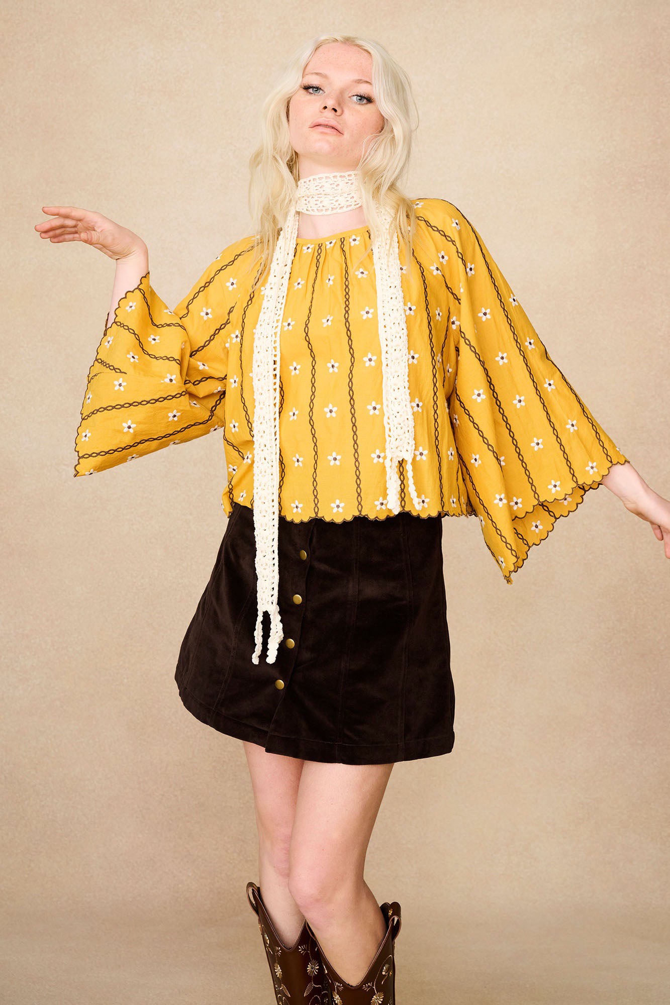 Model wearing The Hippie Shake's yellow embroidered smock top, styled with our brown velvet skirt and a white lace scarf.