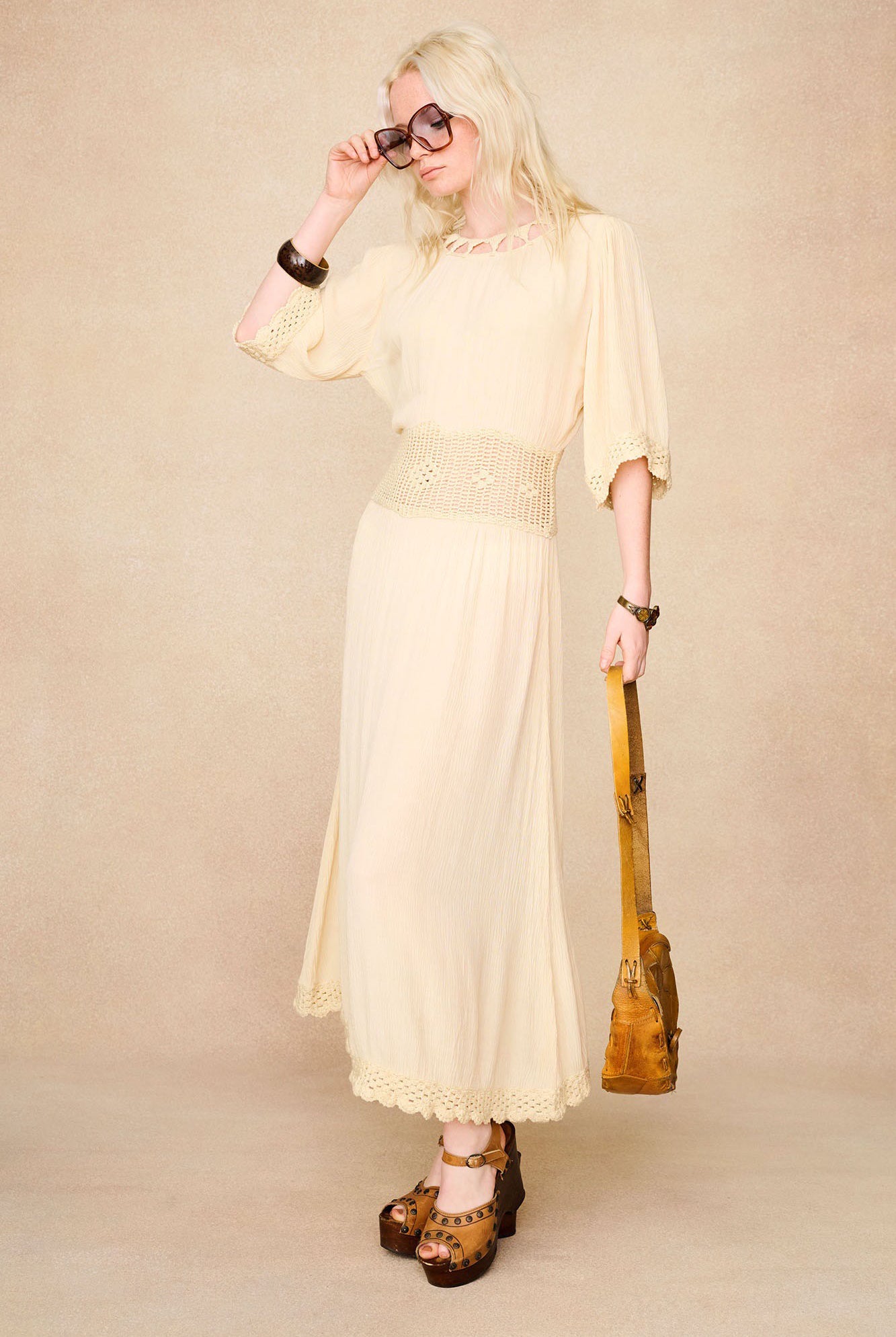 The Hippie Shake's 70s style cream crochet midi dress styled with platforms and vintage accessories.