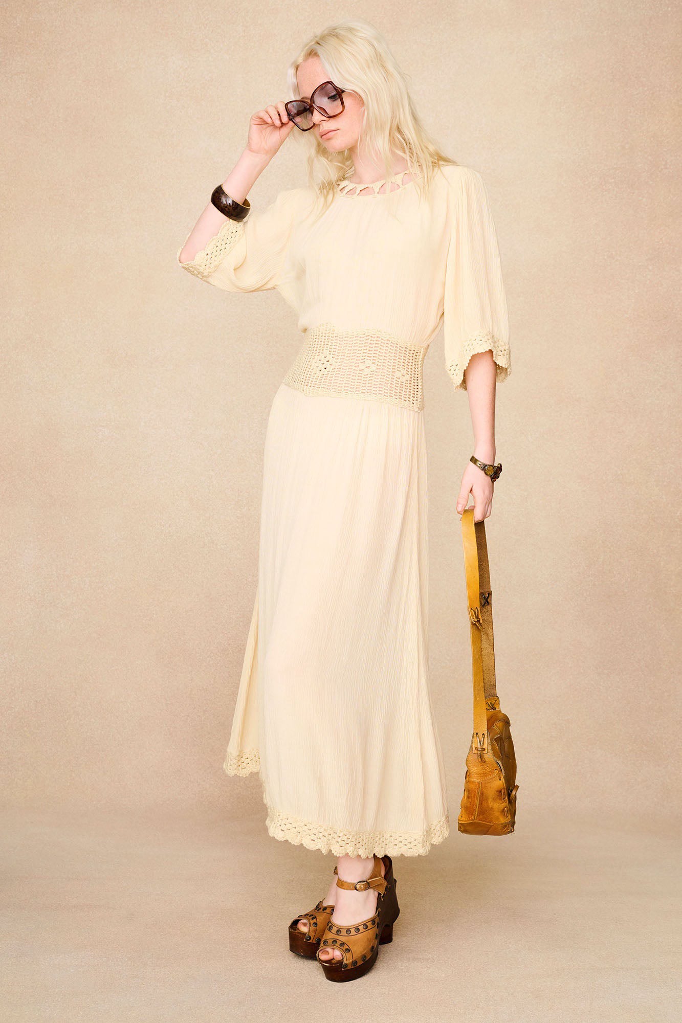 The Hippie Shake's 70s style cream crochet midi dress styled with platforms and vintage accessories.