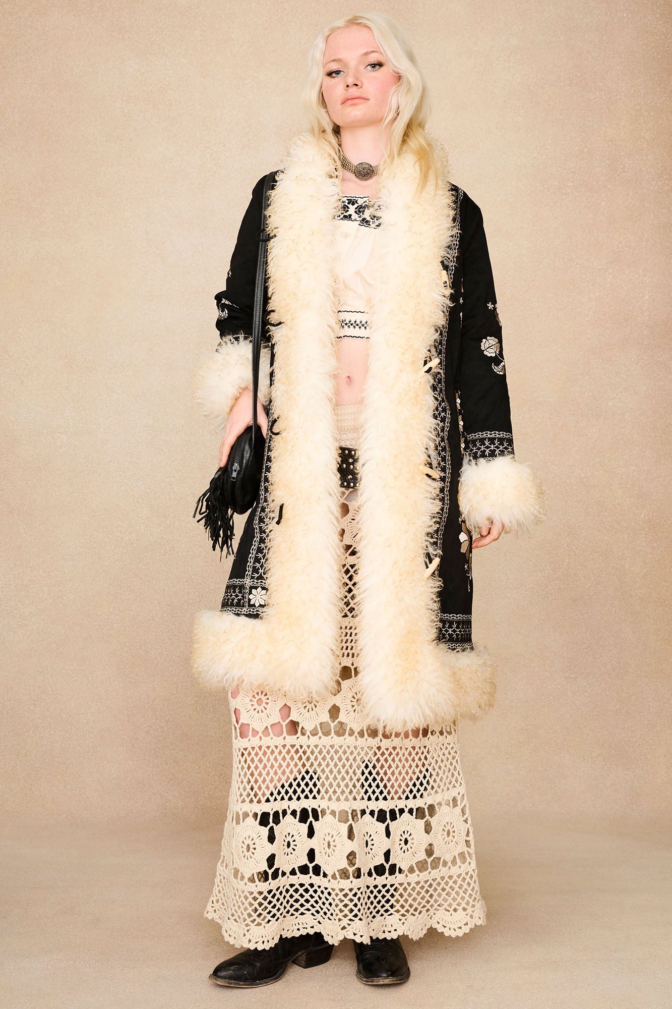 The Hippie Shake's black embroidered Penny Lane coat worn open over our cream embroidered crop top and cream maxi skirt.