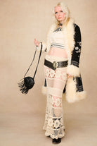 The Hippie Shake's black vintage style afghan coat worn open over our cream embroidered crop top and cream maxi skirt.