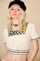 The Hippie Shake's cream embroidered floral crop top styled with our black corduroy baker hat and statement choker.