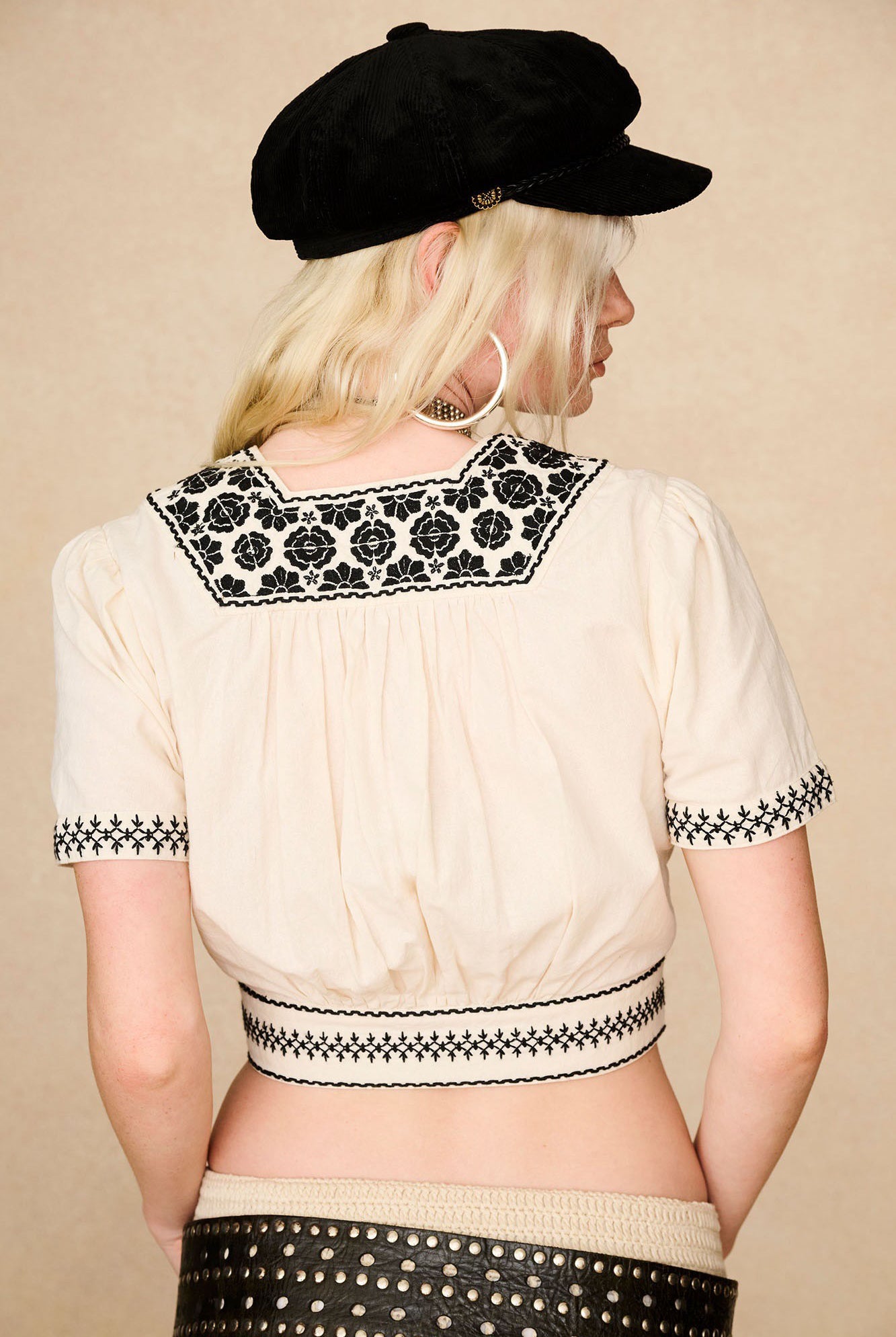 The Hippie Shake's 70s inspired corduroy baker hat styled with with our cream embroidered crop top seen from behind.