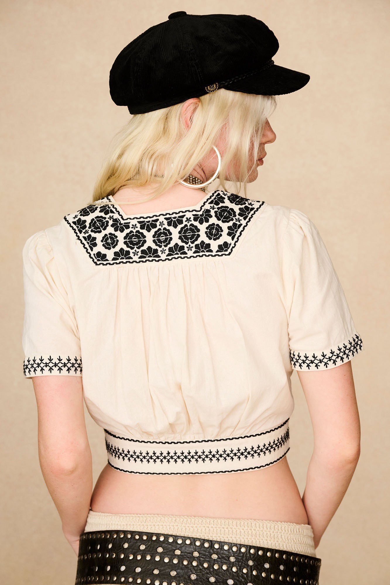 The Hippie Shake's 70s inspired corduroy baker hat styled with with our cream embroidered crop top seen from behind.