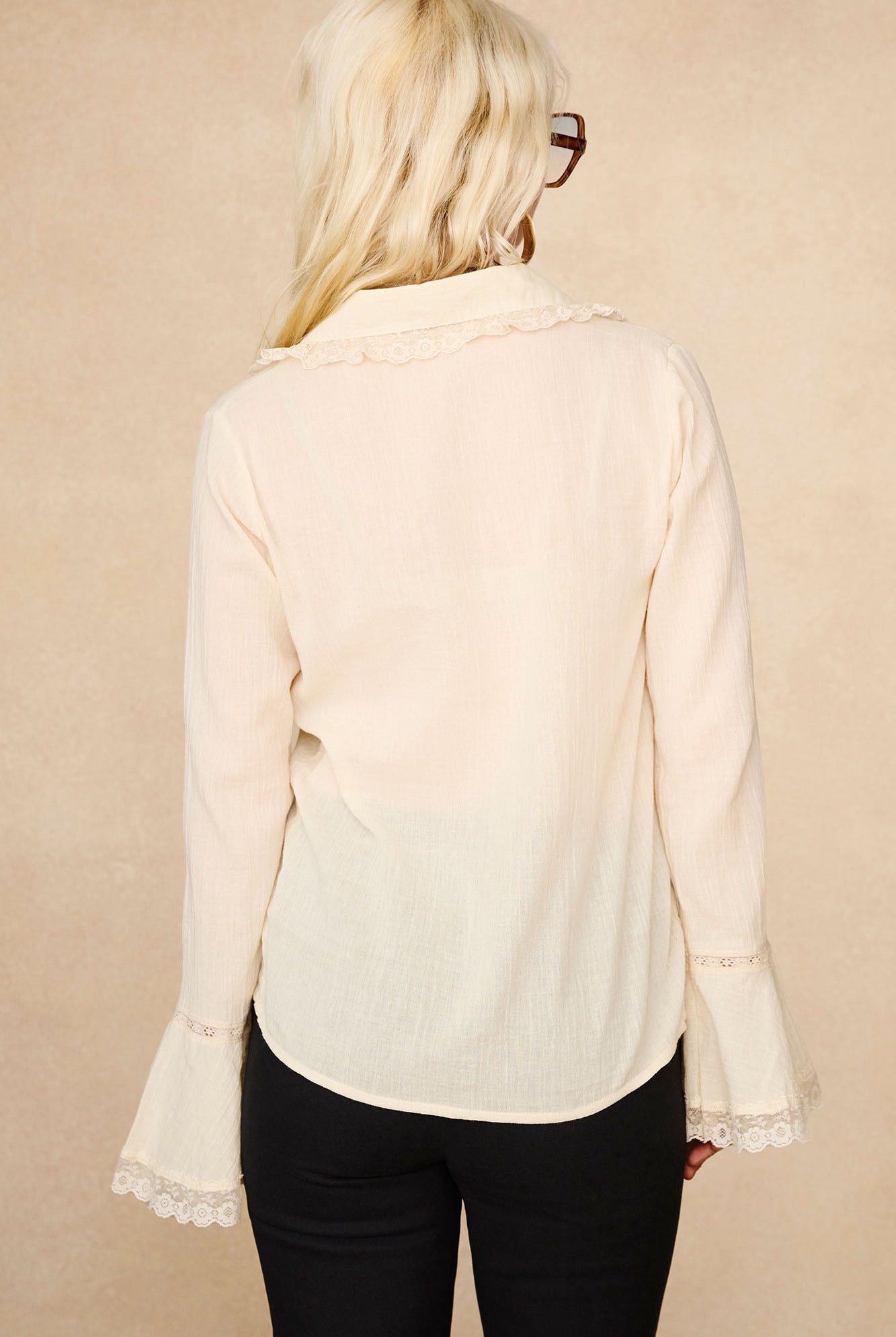 Back view of The Hippie Shake's lace trim cream ruffle blouse showing vintage style fluttery sleeves and floral lace collar.