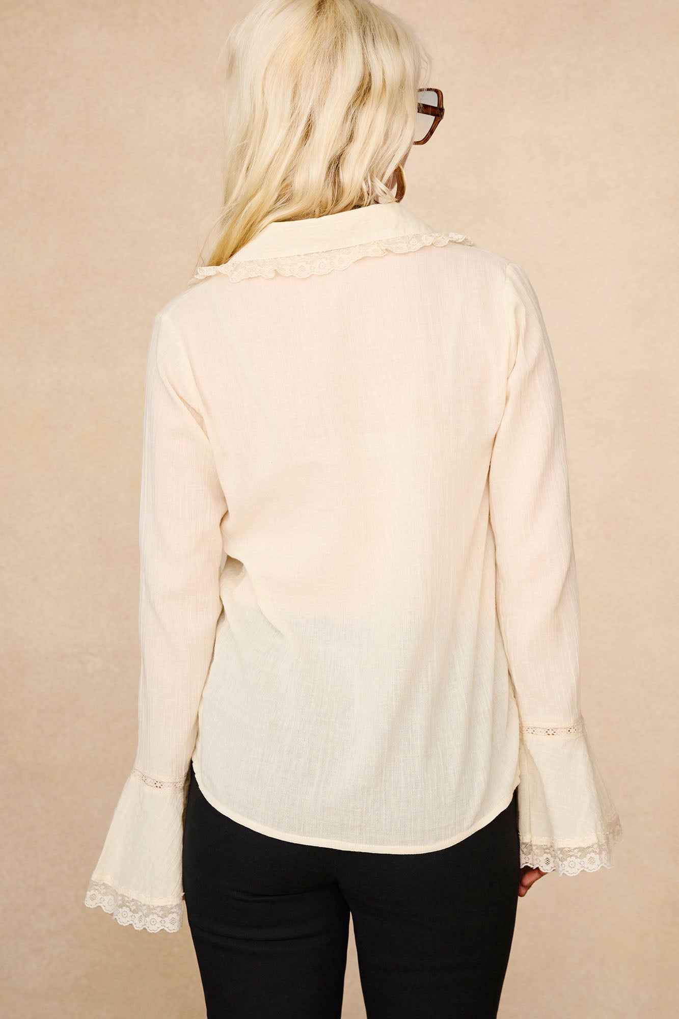 Back view of The Hippie Shake's lace trim cream ruffle blouse showing vintage style fluttery sleeves and floral lace collar.