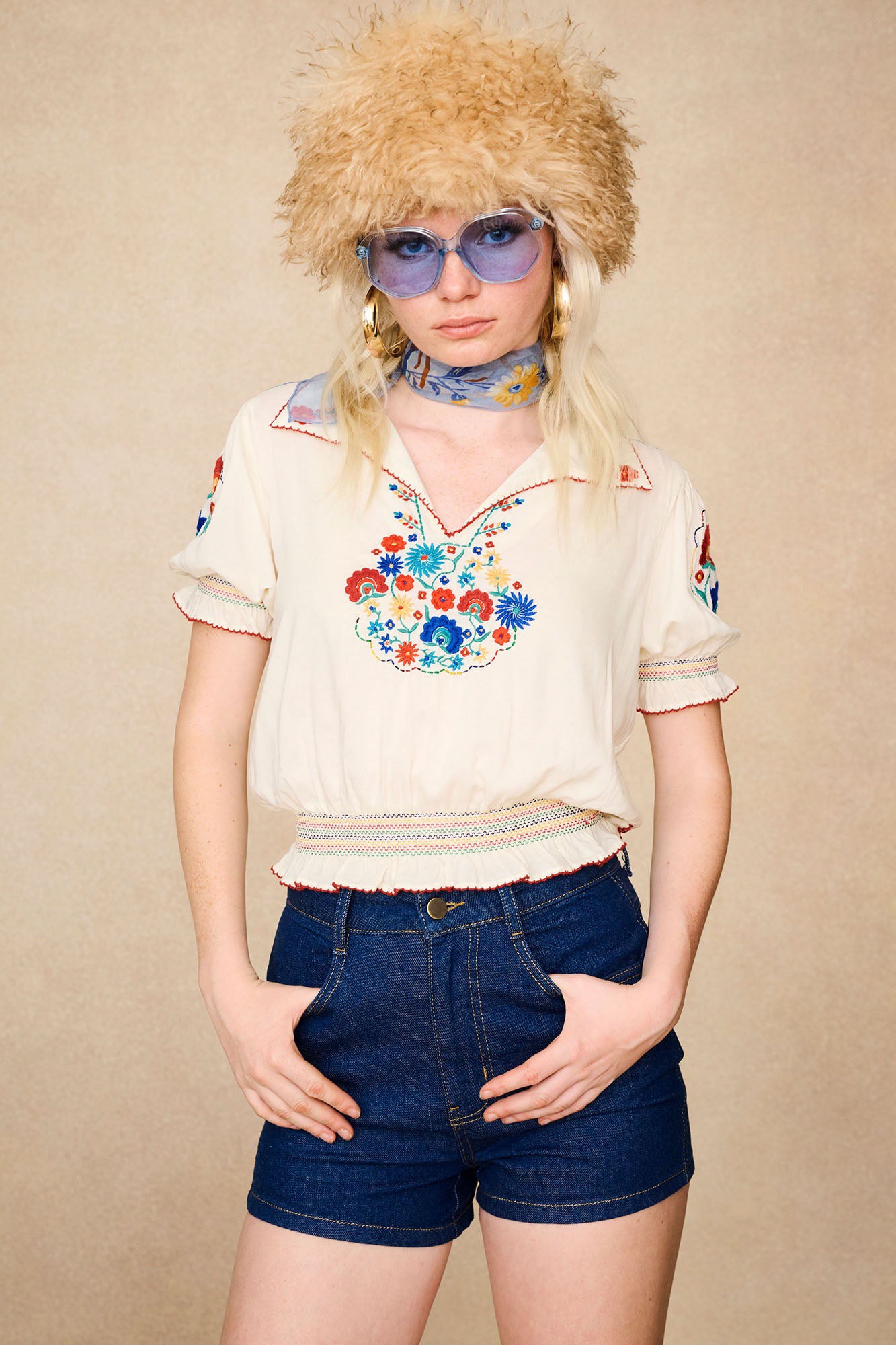The Hippie Shake's cream floral Penny Lane blouse styled with our denim high-waisted shorts and faux fur hat.