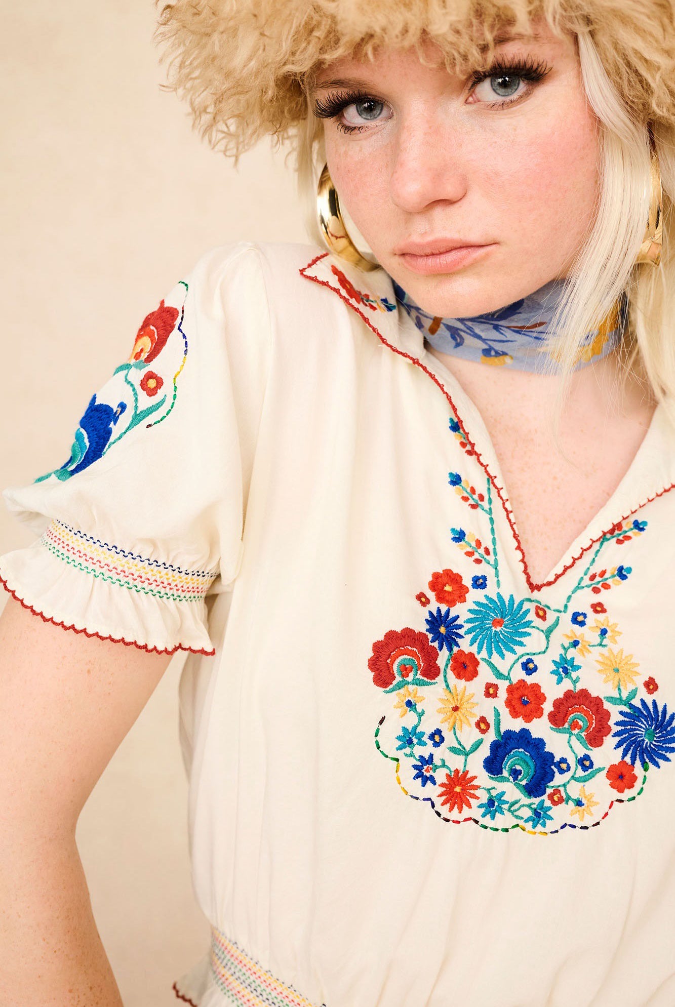 Close-up of The Hippie Shake's 70s inspired cream floral Penny Lane blouse with colourful embroidery and scalloped trim.