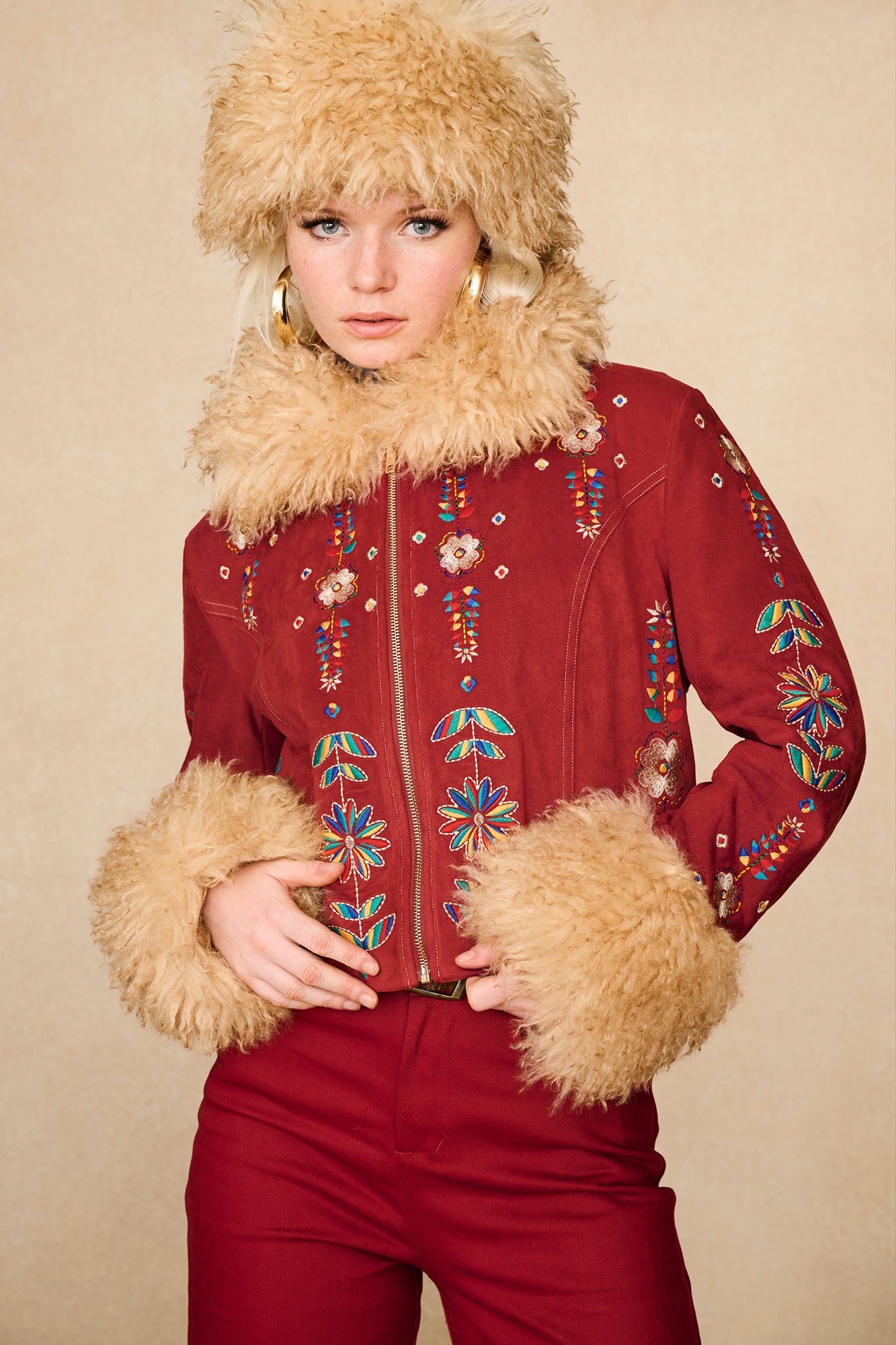 Front view of The Hippie Shake's red embroidered Penny Lane coat highlighting the colourful floral embroidery and faux fur edges.