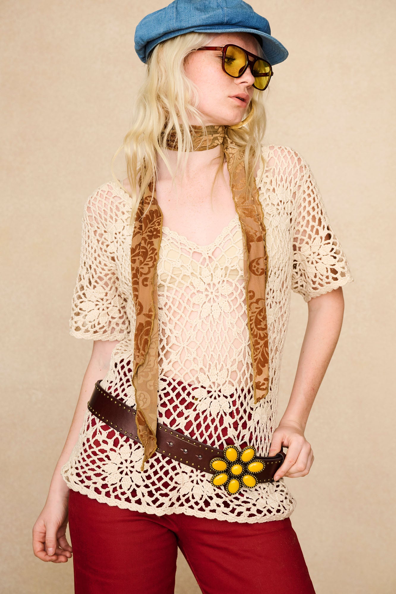 The Hippie Shake's cream floral crochet top styled with our red embroidered flares and yellow flower buckle belt.