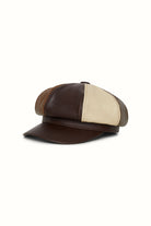 Studio shot of The Hippie Shake’s brown panelled baker hat with contrasting tan and cream leather sections.