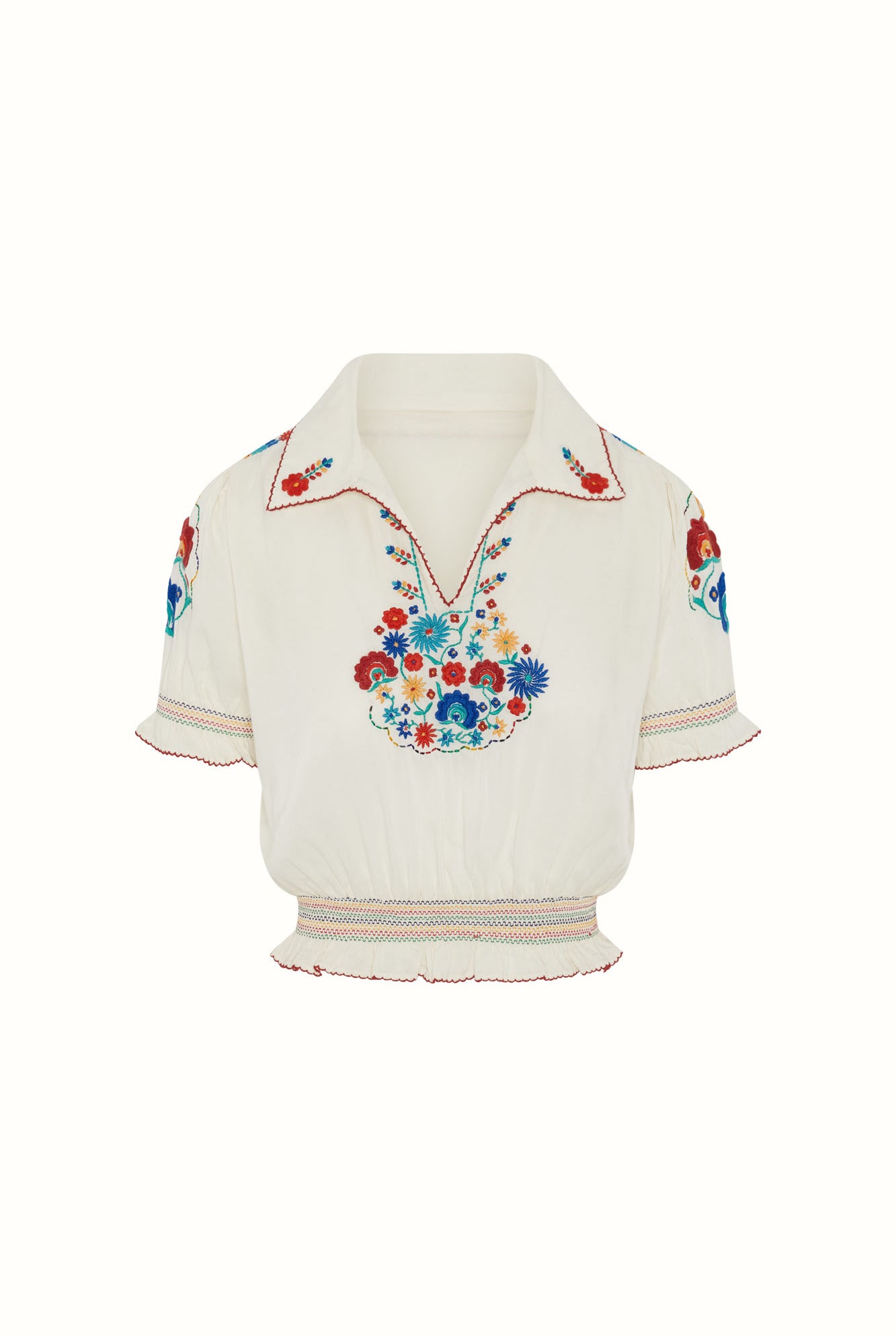 Flat lay of The Hippie Shake's cream floral Penny Lane blouse with red stitching and rainbow shirring.