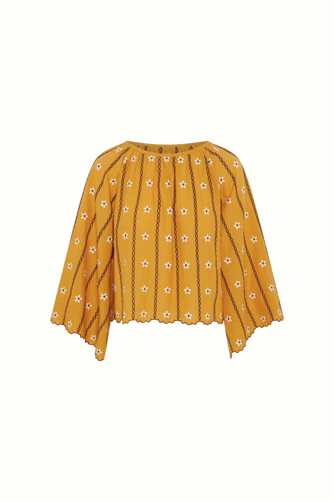 Flat lay of The Hippie Shake's yellow embroidered smock top featuring daisy stitching and scalloped edges.