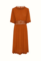 Flat lay of The Hippie Shake's orange crochet midi dress with lace trim and sheer waistband panel.