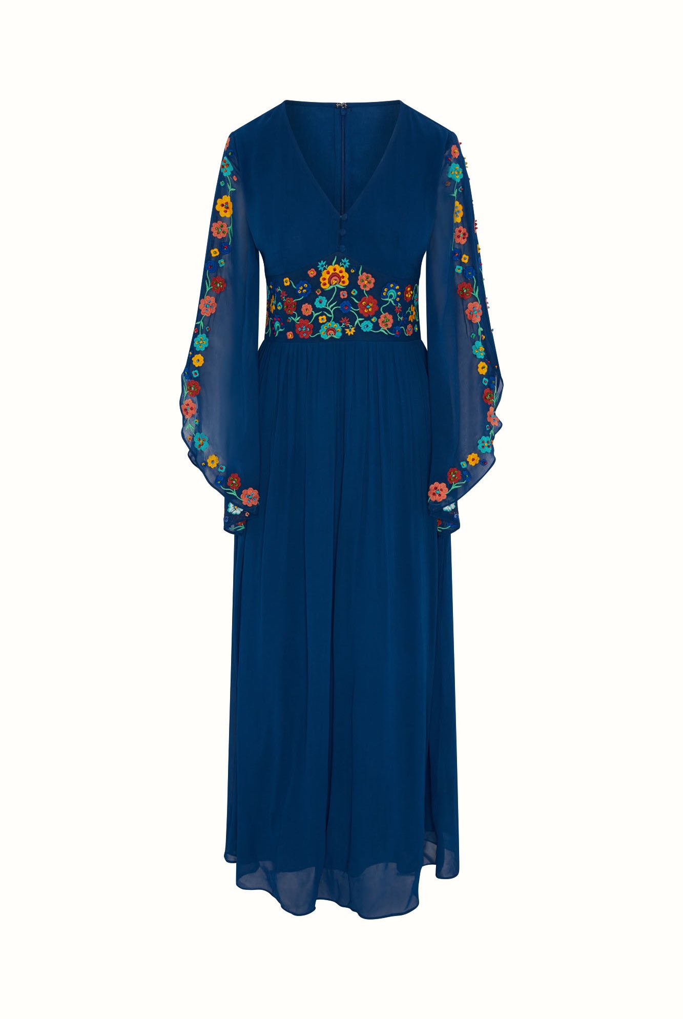 Flat lay of The Hippie Shake's blue floral embroidered maxi dress with flared sleeves and floral embroidery on a white background.