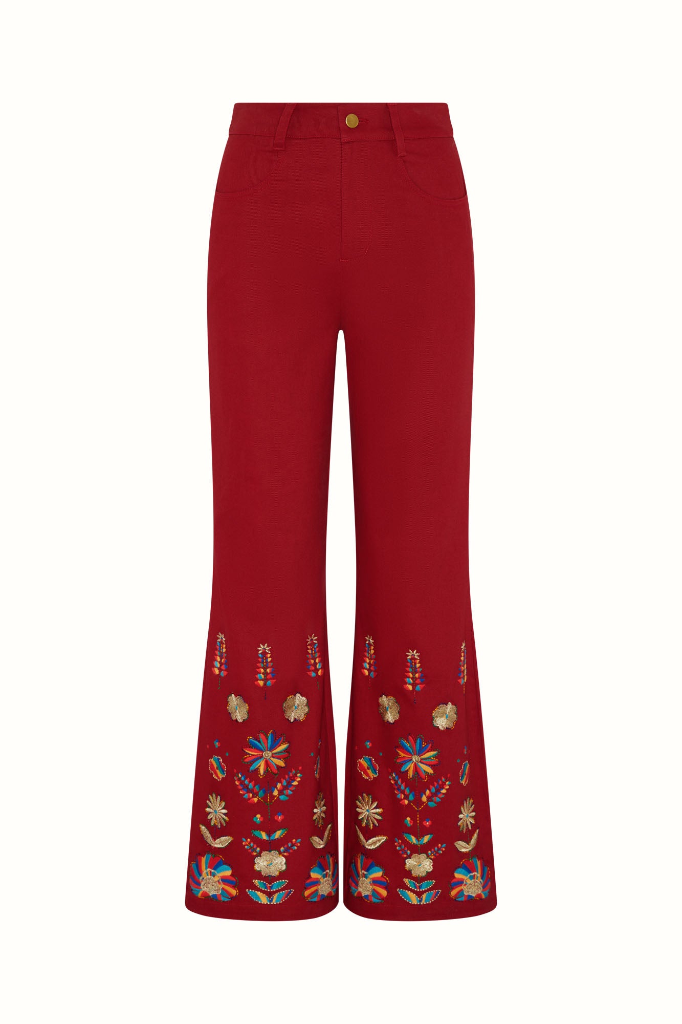 Flat lay of The Hippie Shake's red embroidered flared trousers against a white background showing symmetrical floral motifs at the bottom.