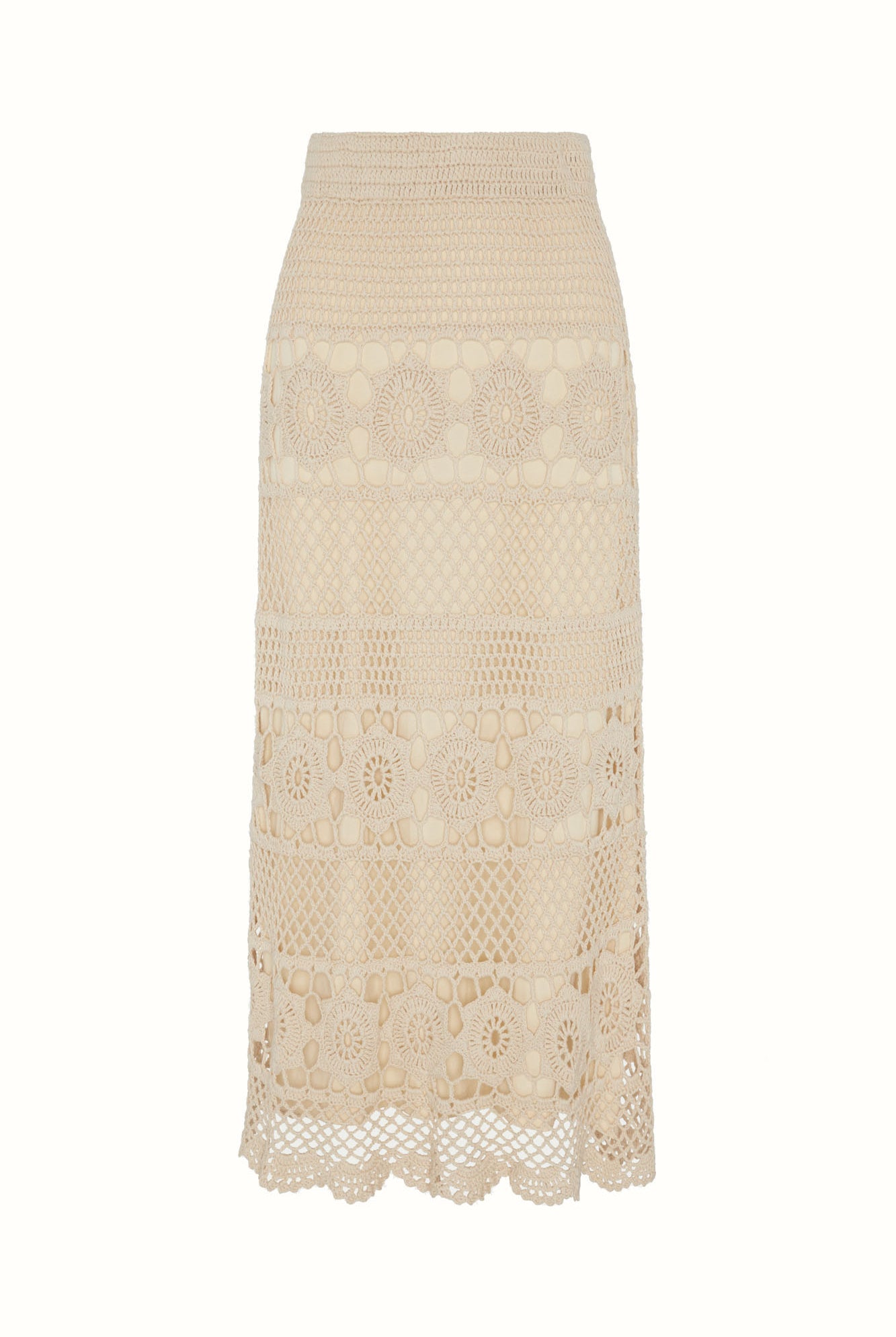 Flat lay of The Hippie Shake's cream crochet maxi skirt showing full crochet pattern and scalloped edging.