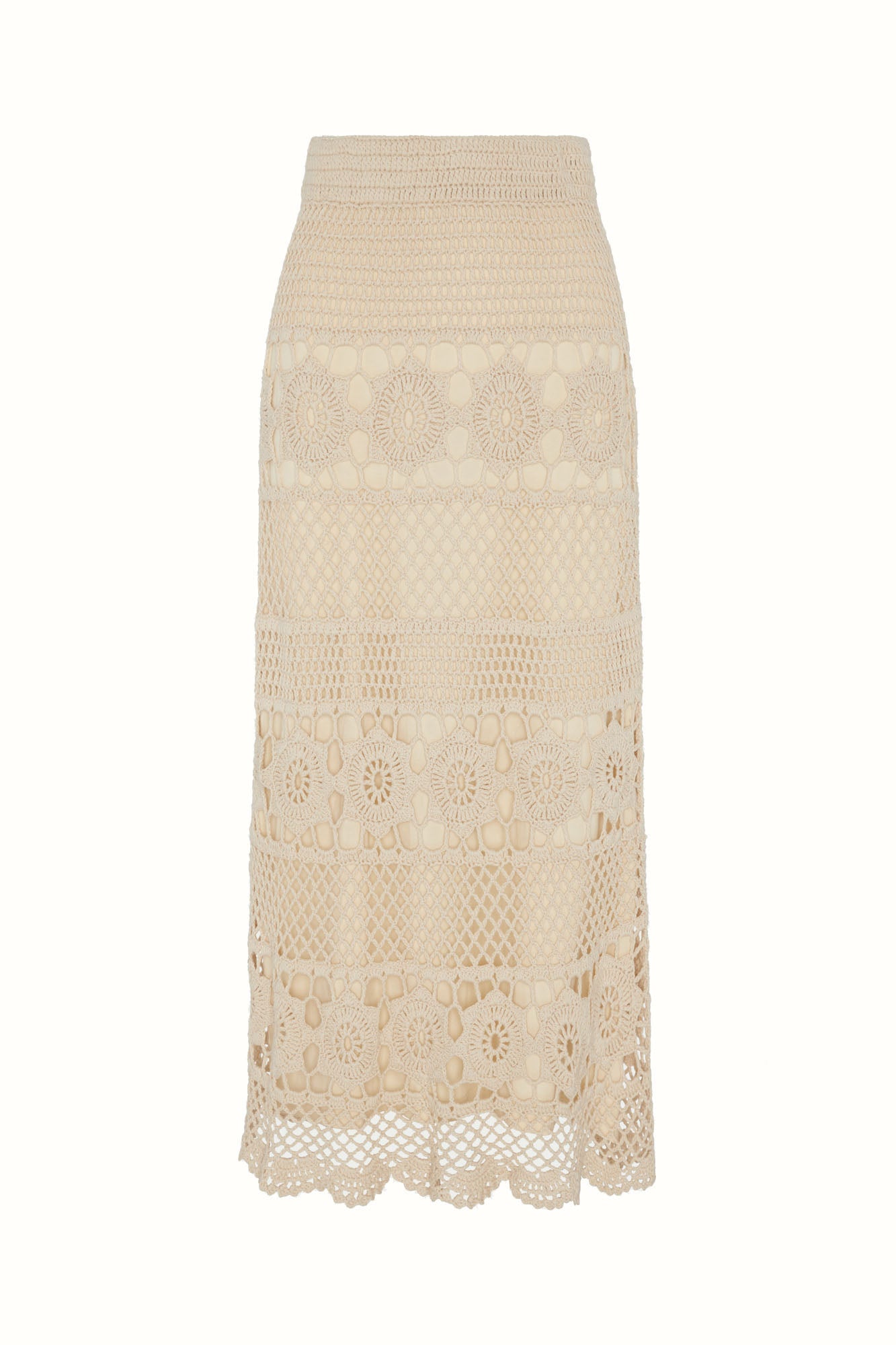 Flat lay of The Hippie Shake's cream crochet maxi skirt showing full crochet pattern and scalloped edging.