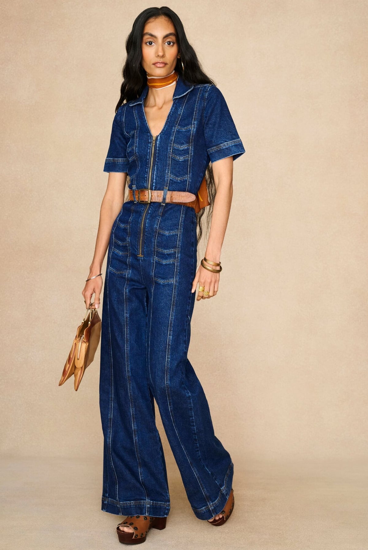 Model wearing 70s style denim jumpsuit by The Hippie Shake - front view