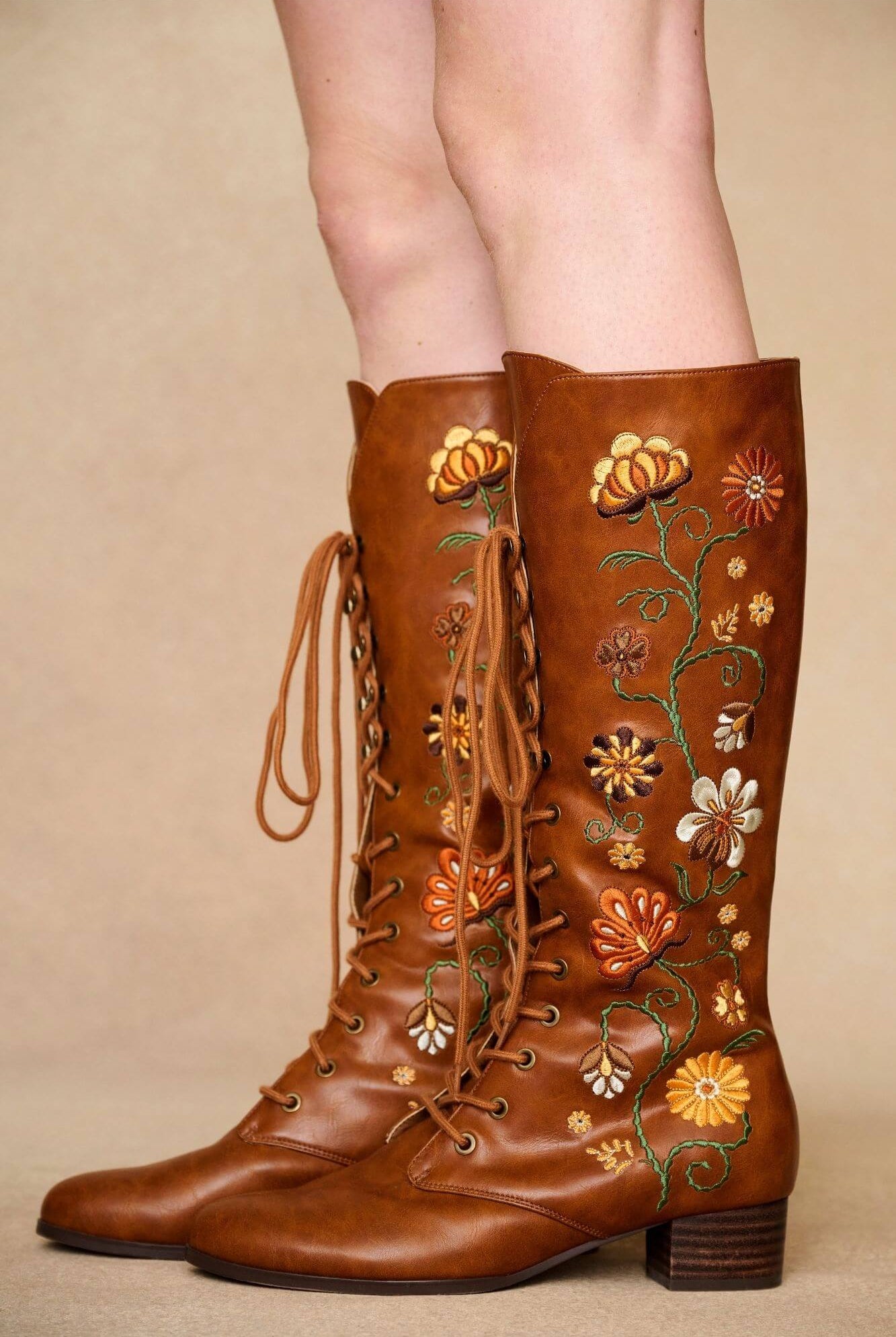 Side view brown embroidered Penny Lane boots in tan faux leather with lace-up front and block heel. Vintage-inspired boho boots by The Hippie Shake