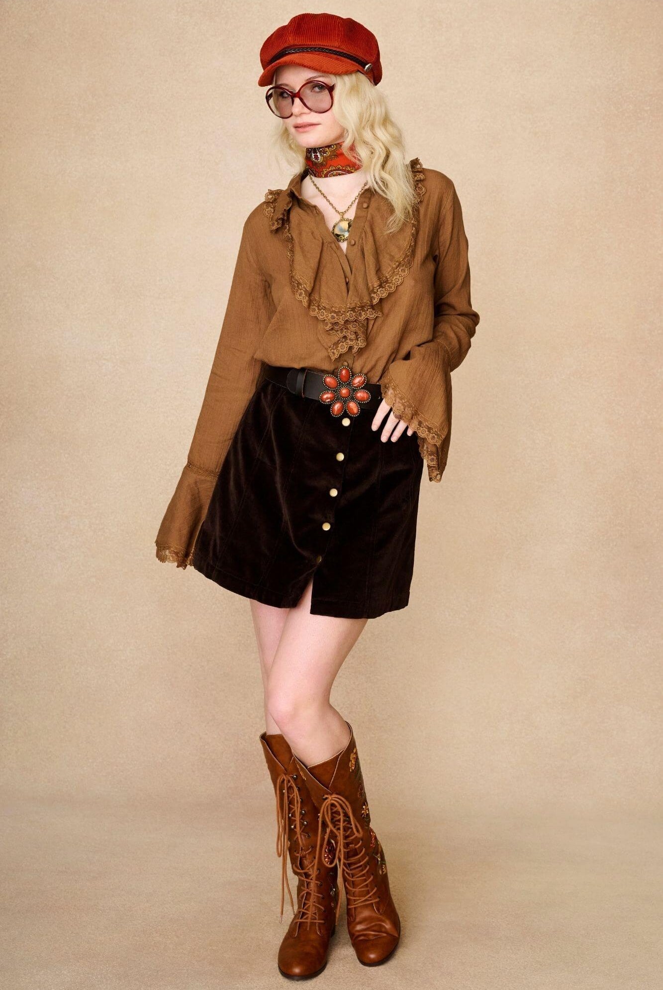 Model wears vintage style ruffle blouse and 70s inspired velvet cord skirt with brown floral embroidered Penny Lane lace up boots by The Hippie Shake