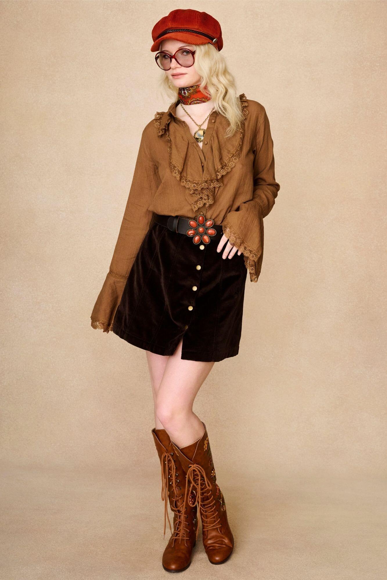 Model wears vintage style ruffle blouse and 70s inspired velvet cord skirt with brown floral embroidered Penny Lane lace up boots by The Hippie Shake