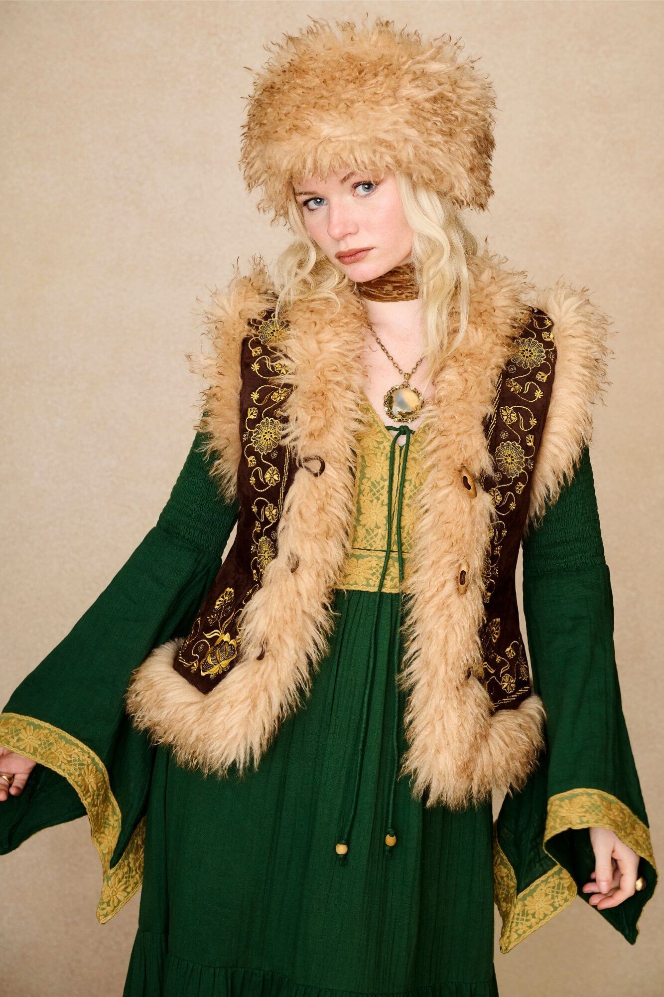 Model wears brown embroidered Penny Lane vest in faux suede with faux fur trim. A 70s-inspired boho layering piece made for vintage and festival styling by The Hippie Shake - front view