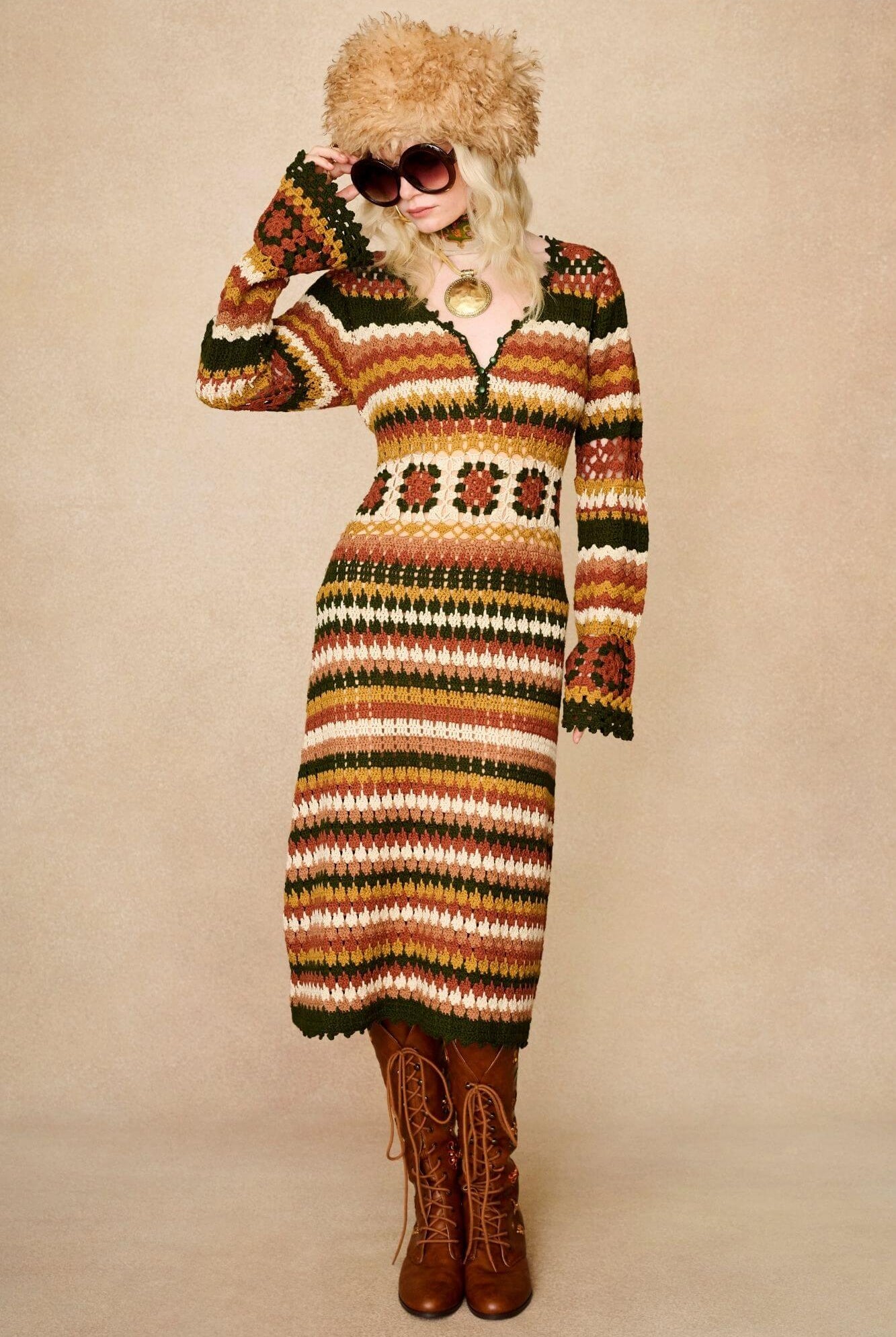 Model wears striped crochet midi dress hand crocheted in cotton with 70s-inspired detailing by The Hippie Shake. Glasses and hat front view