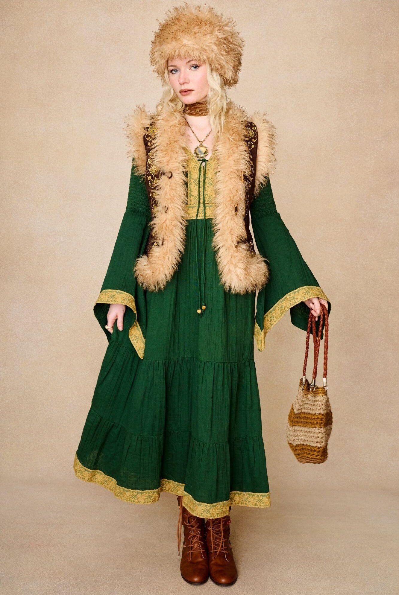 Model wears brown embroidered Penny Lane vest in faux suede with faux fur trim. A 70s-inspired boho layering piece made for vintage and festival styling by The Hippie Shake - standing front view