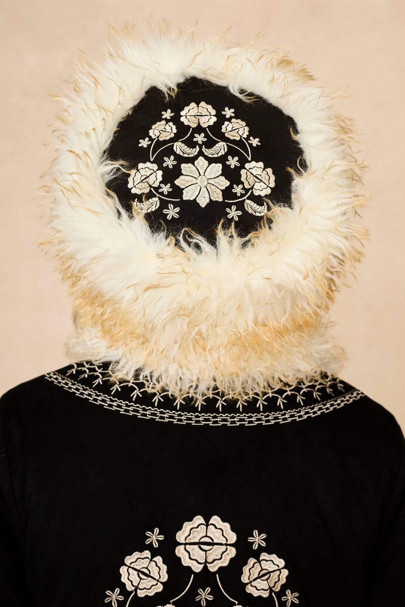 Model wears cream faux fur hat with vintage detailing and embroidered finish. A 70s-inspired boho winter hat made for statement styling by The Hippie Shake - back view