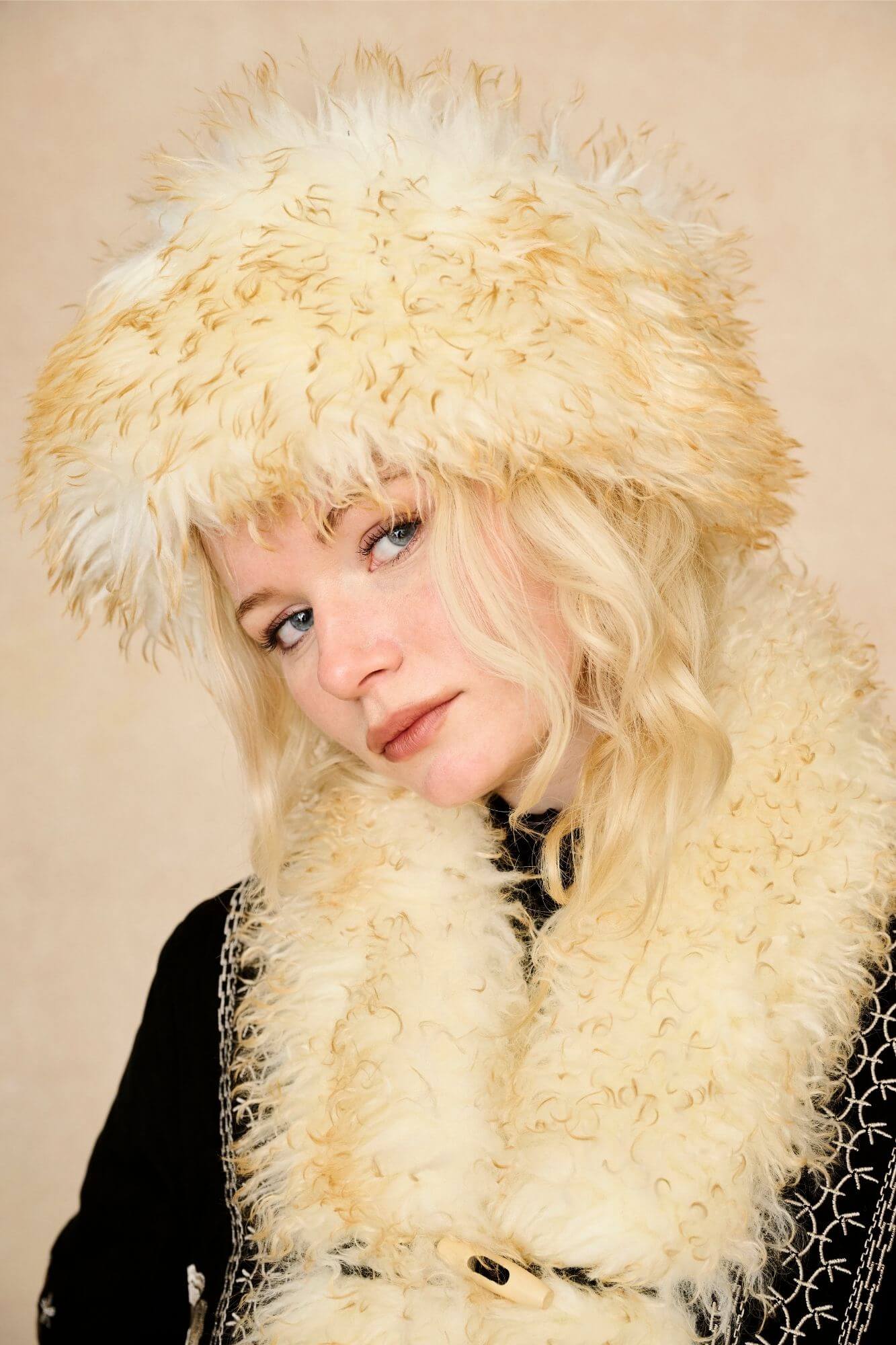 Model wears cream faux fur hat with vintage detailing and embroidered finish. A 70s-inspired boho winter hat made for statement styling by The Hippie Shake - front view