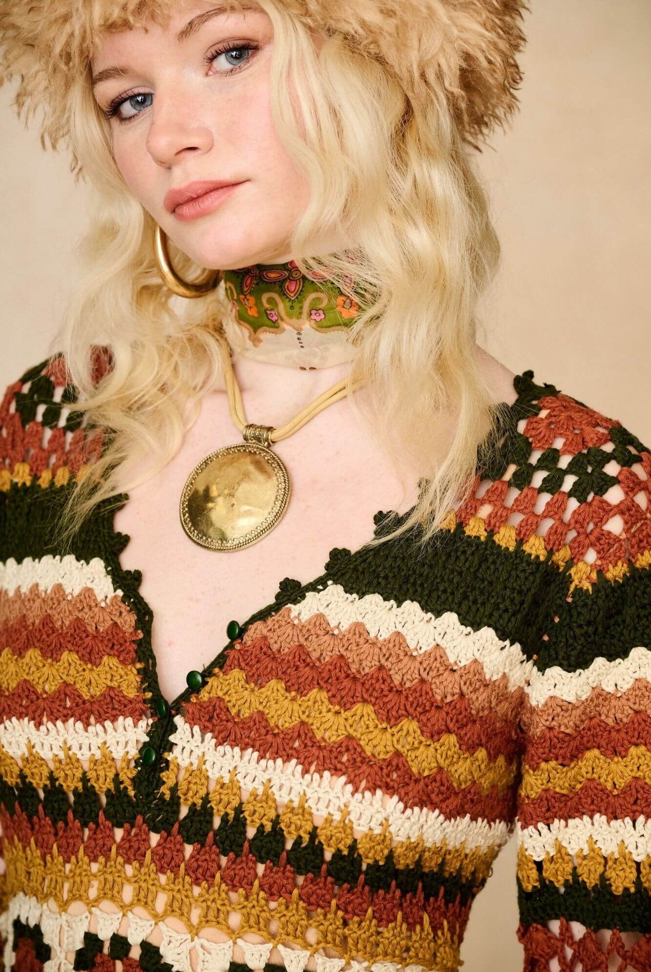 Model wears striped crochet midi dress hand crocheted in cotton with 70s-inspired detailing by The Hippie Shake. Front close up view