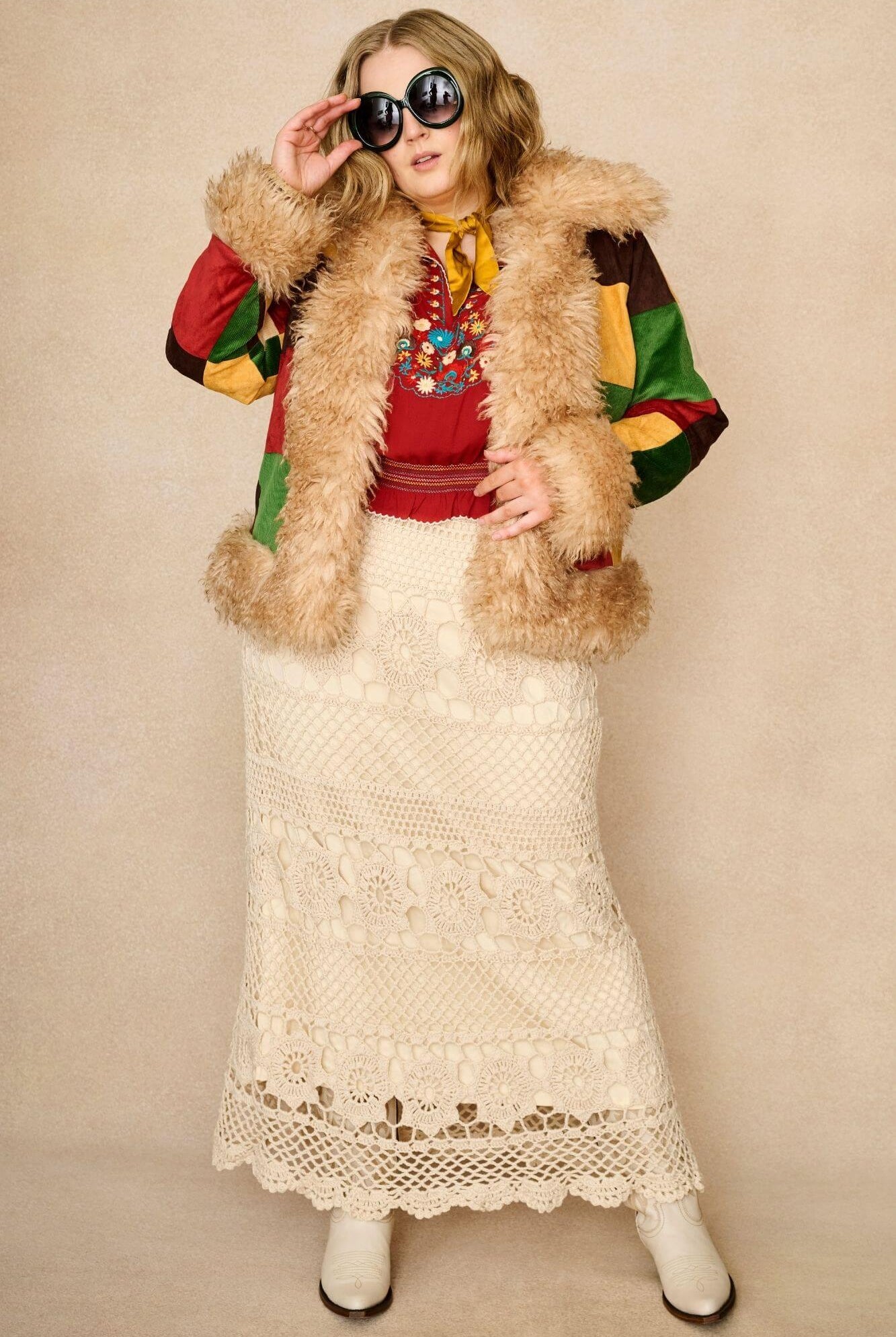Model wears red floral embroidered Penny Lane blouse in soft cotton with shirred details. A vintage-inspired boho blouse made for everyday and festival styling by The Hippie Shake. Paired with penny lane coat and crochet skirt
