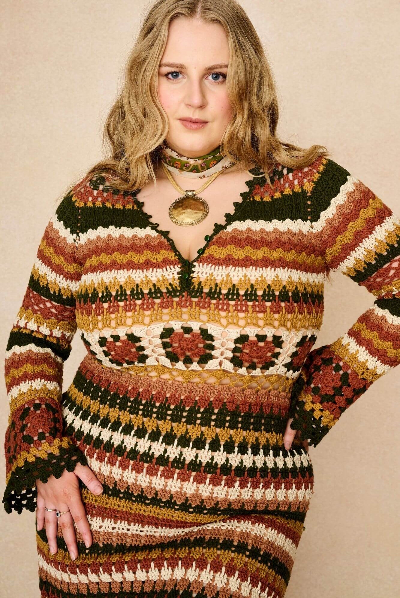 Model wears striped crochet midi dress hand crocheted in cotton with 70s-inspired detailing by The Hippie Shake. Front view