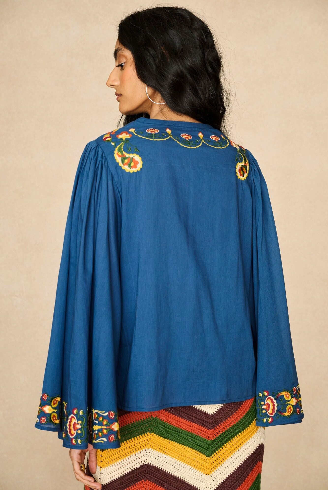 Model wearing 70s blue long sleeve top by The Hippie Shake, back view