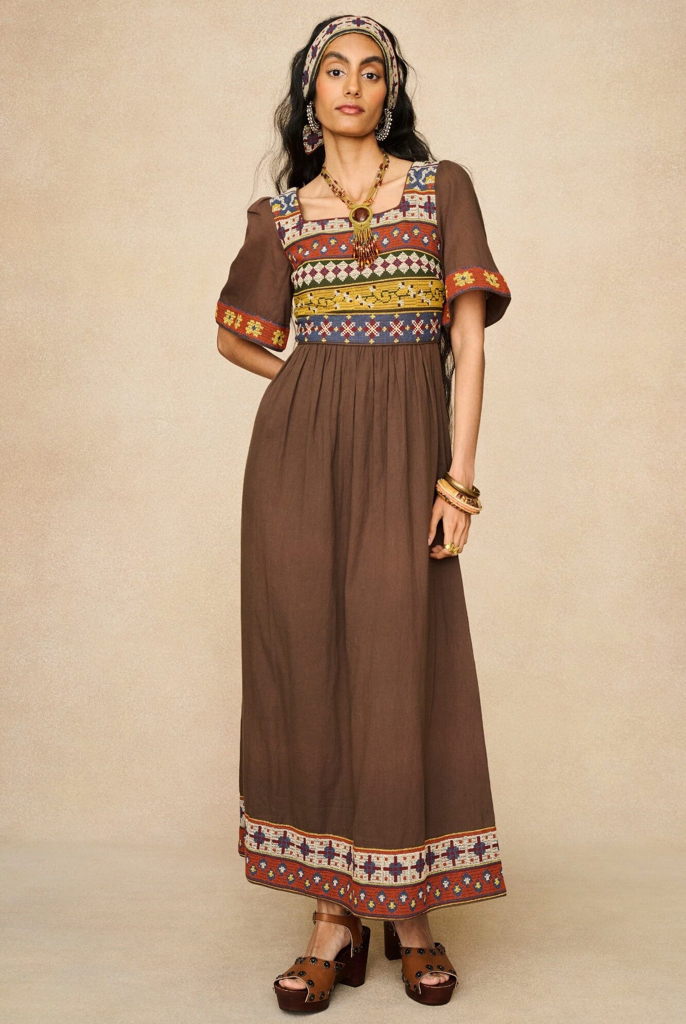 Model wearing brown embroidered maxi dress by The Hippie Shake, front view