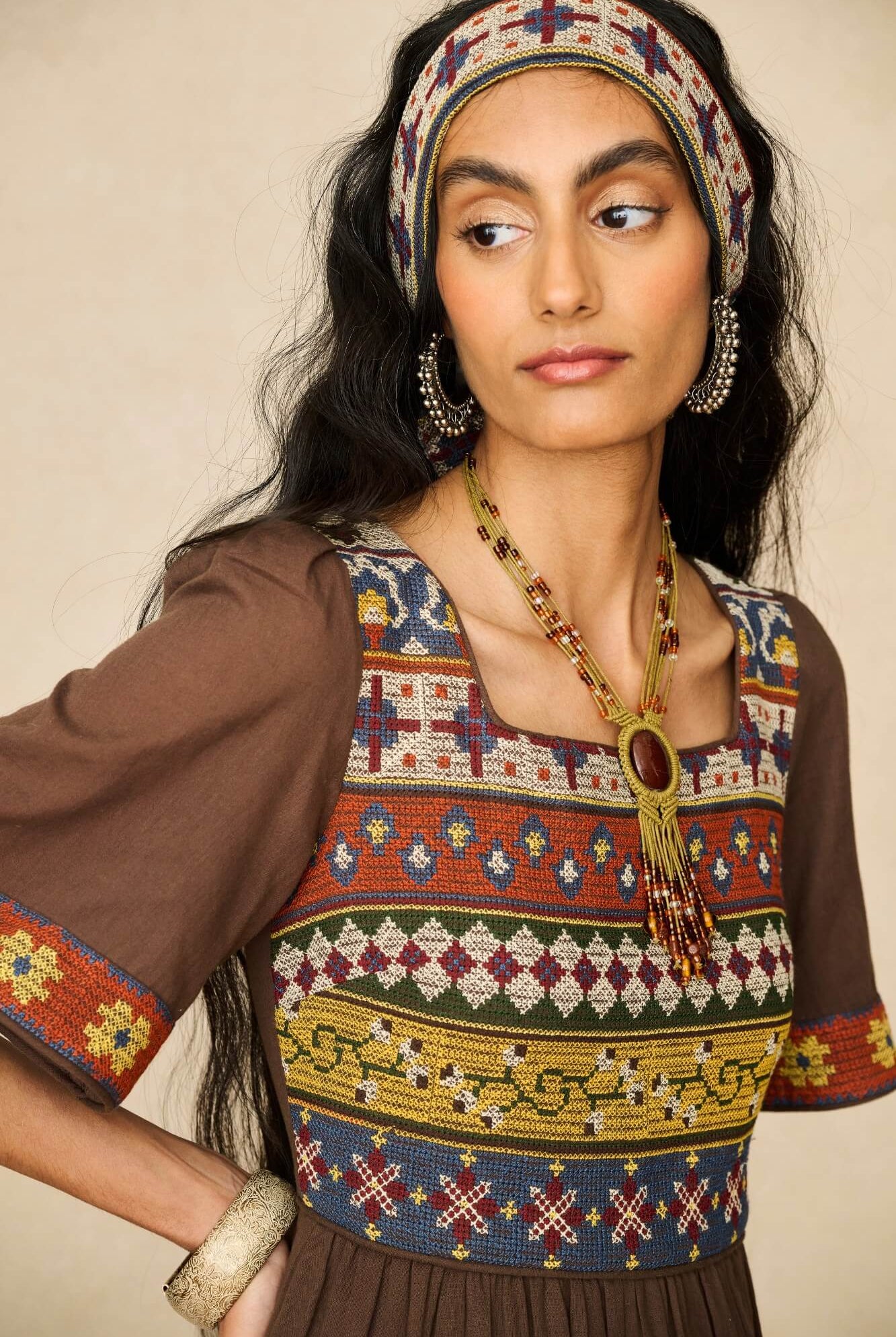 Model wearing brown embroidered maxi dress by The Hippie Shake, close up