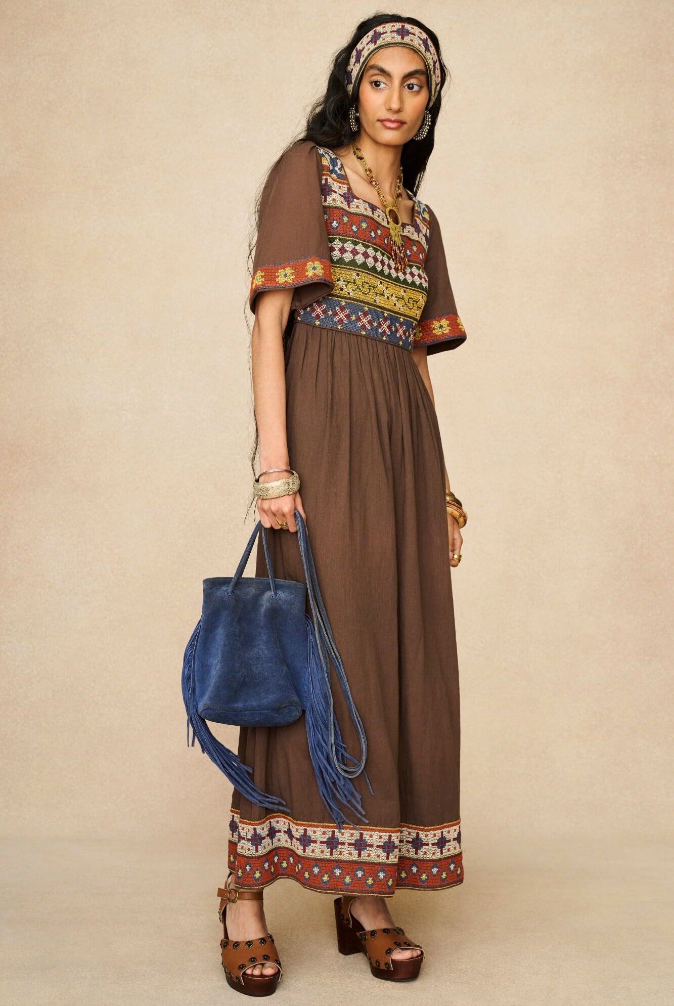 Model wearing brown embroidered maxi dress by The Hippie Shake, front view
