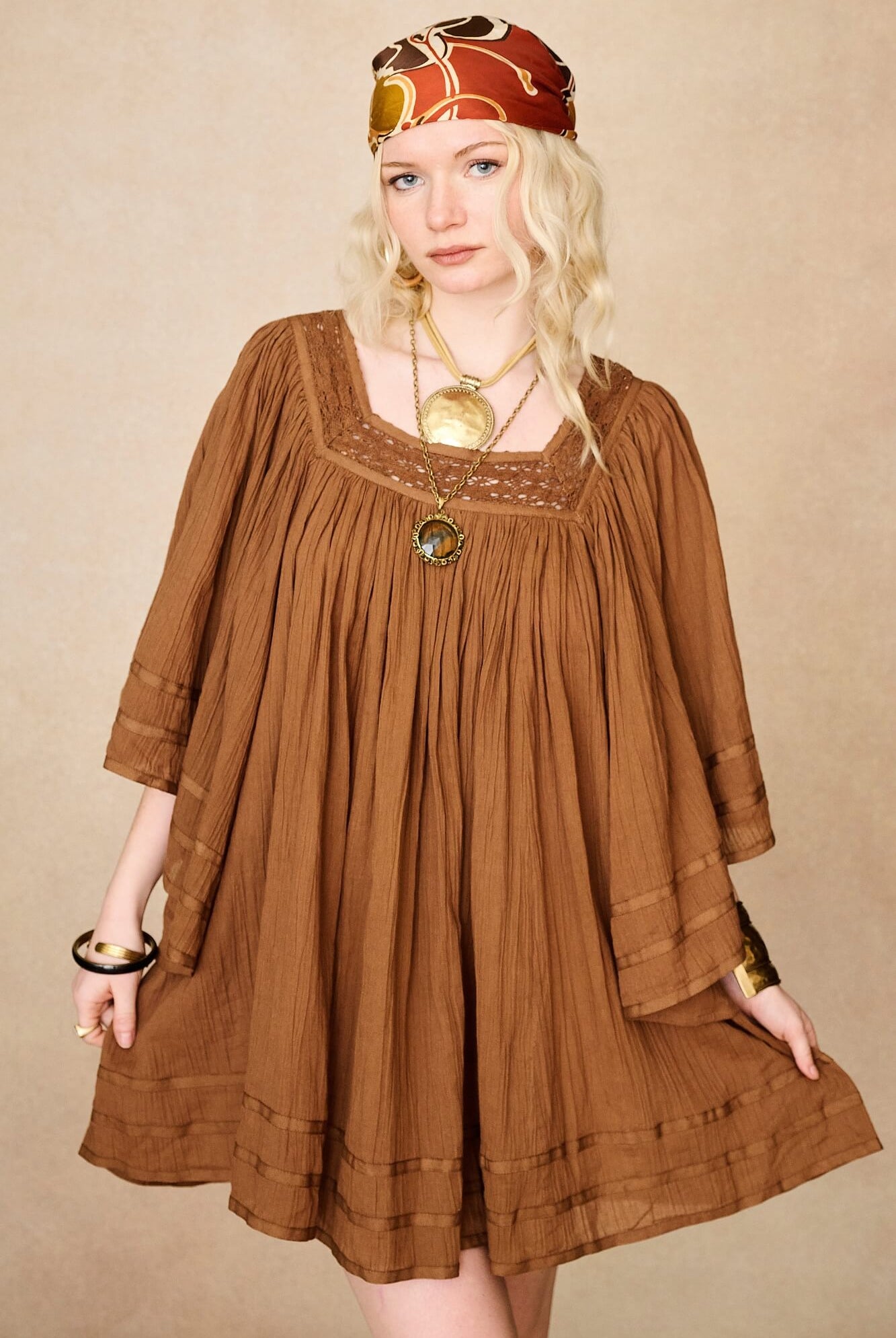 Model wearing 70s brown mini dress with lace-up Penny Lane boots by The Hippie Shake, front view