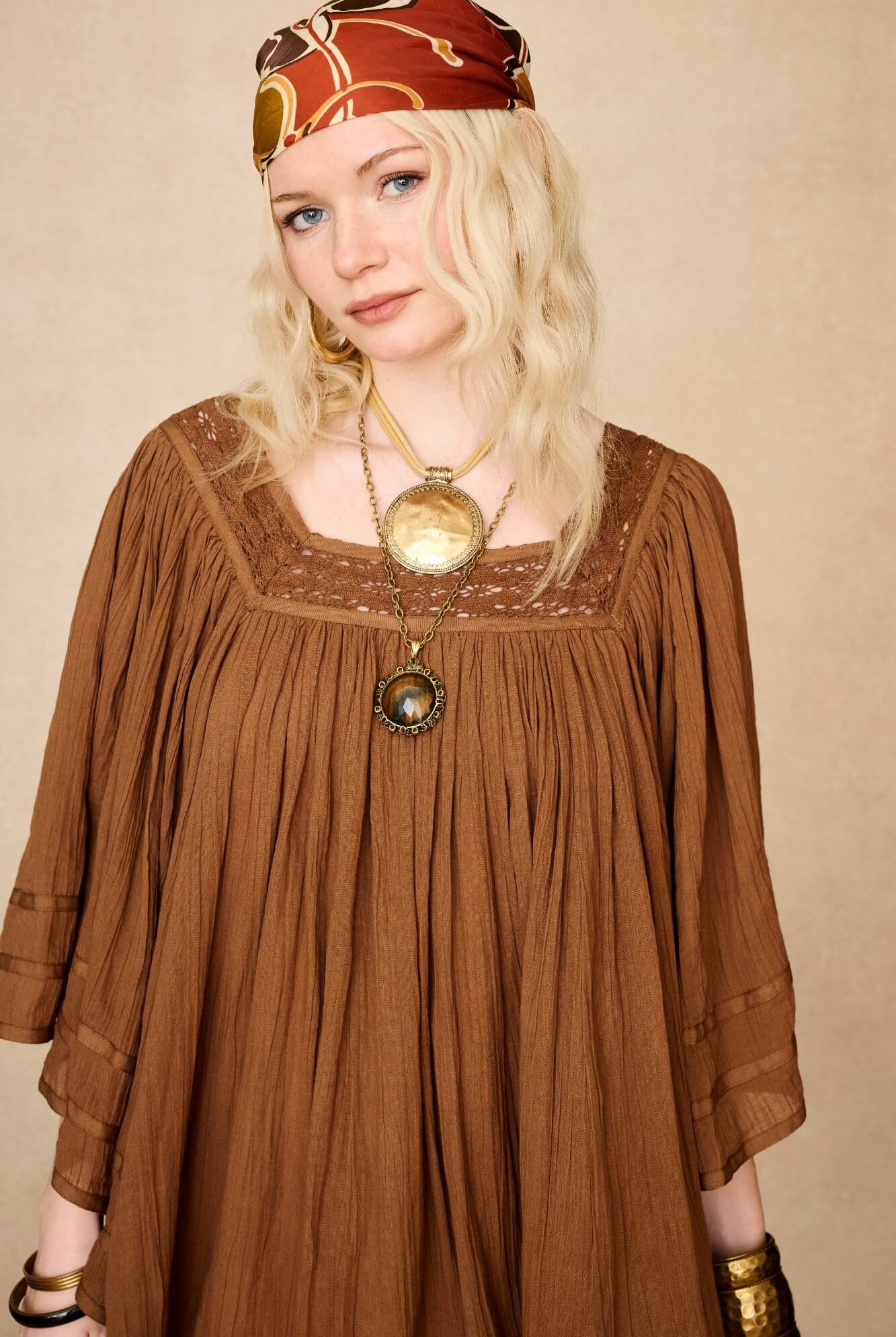 Model wearing 70s brown mini dress with lace-up Penny Lane boots by The Hippie Shake, front close up view